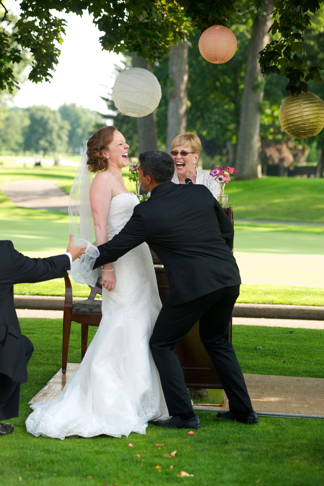 Detroit Golf Club wedding photographer's photo of the bride and groom still battling her veil at the Detroit Golf Club.
